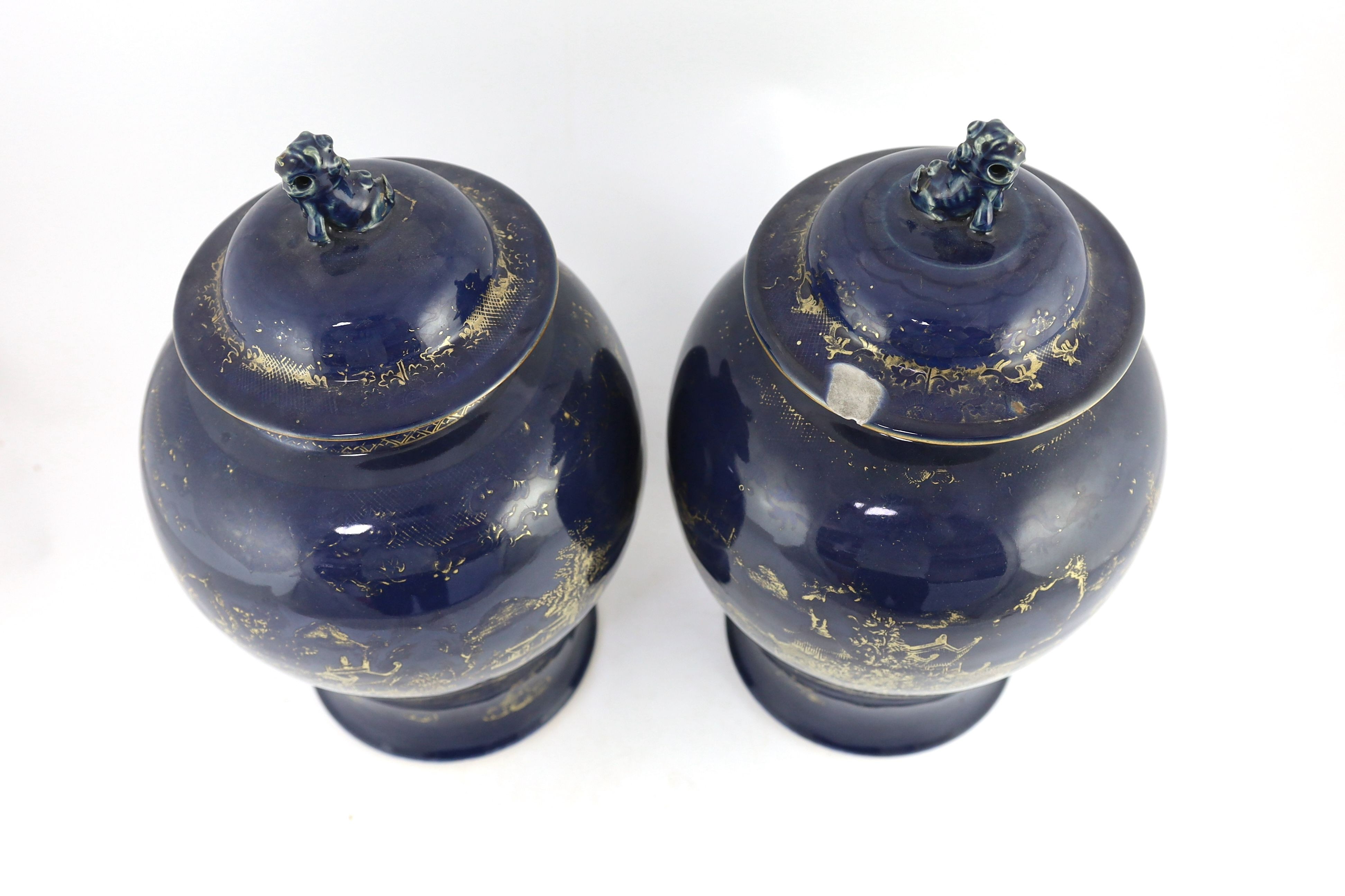 A pair of Chinese gilt-decorated blue ground baluster vases and covers, 19th century, 44 cm high